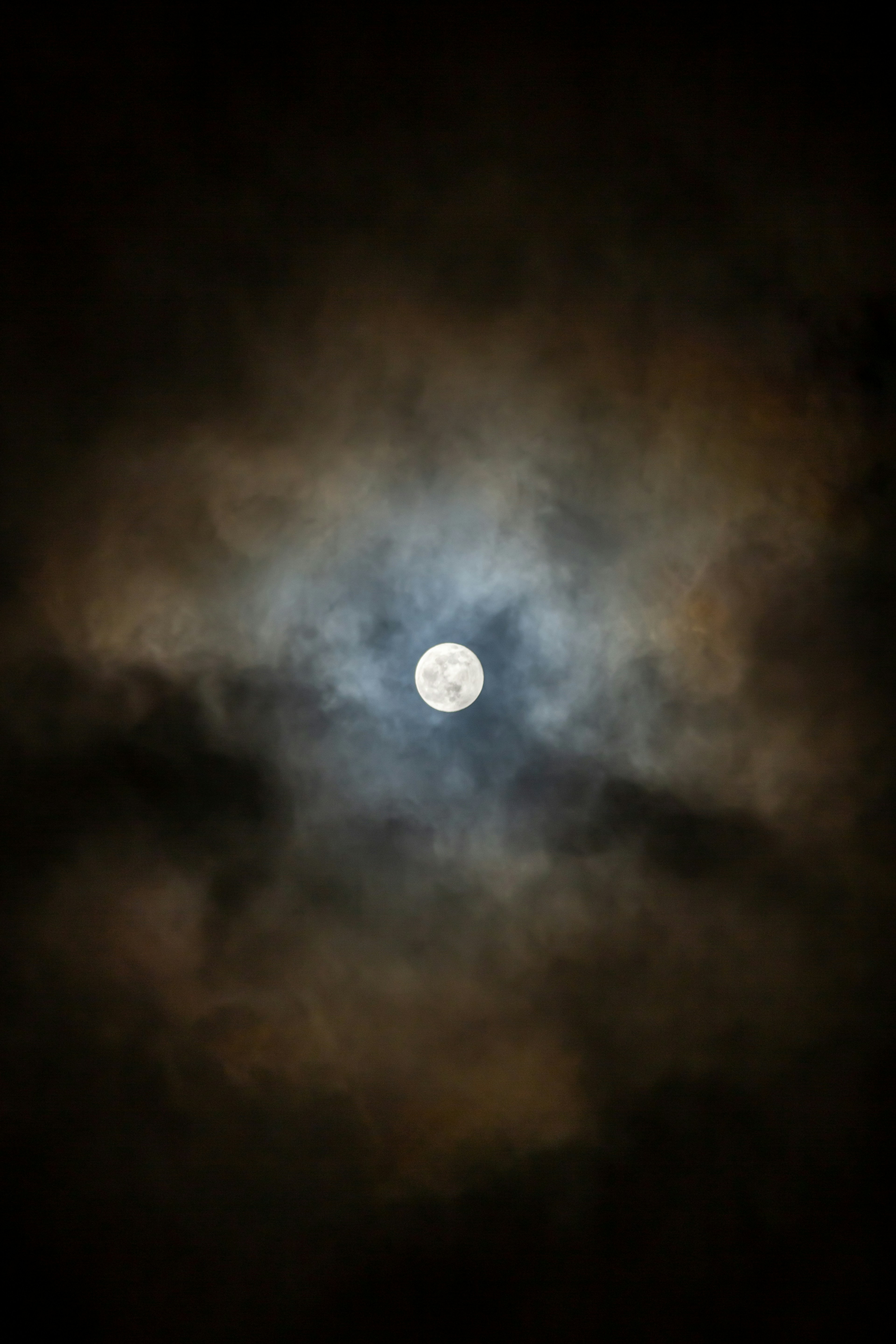 Full Moon Through Cloudy Night Sky