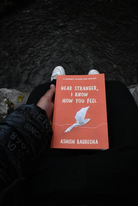 Holding Dear Stranger Book Outdoors
