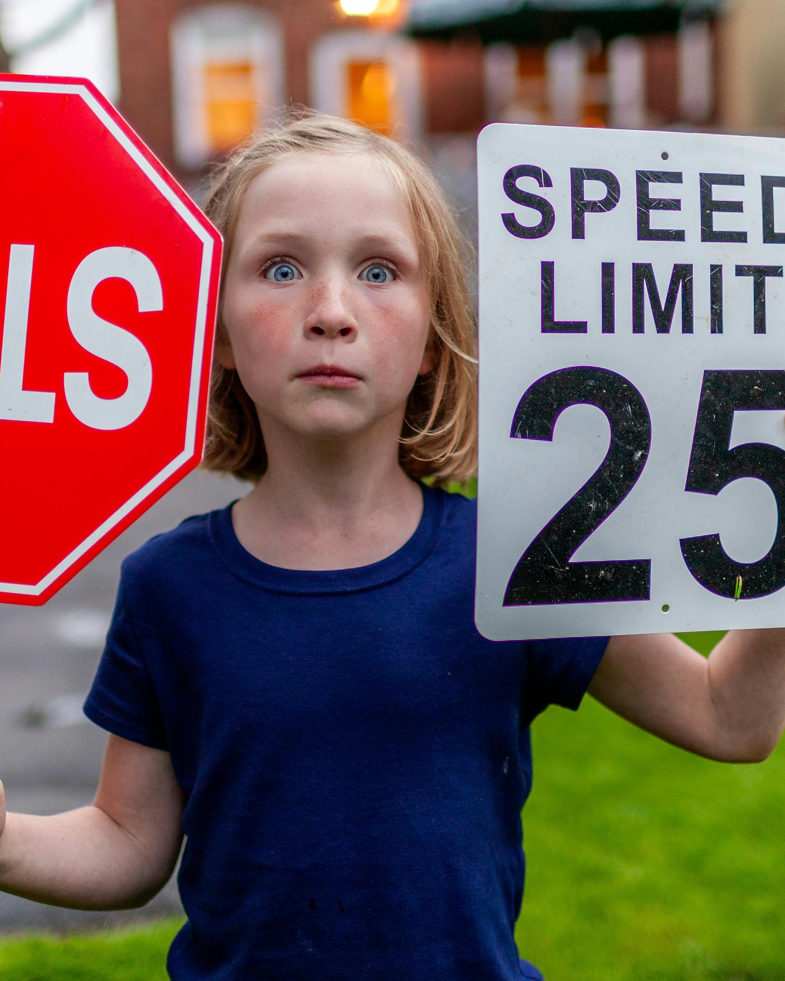 Surprised Girl Holding Road Traffic Signs
