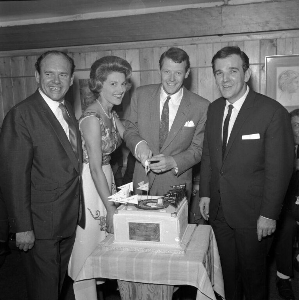 Four People Cutting Celebration Cake
