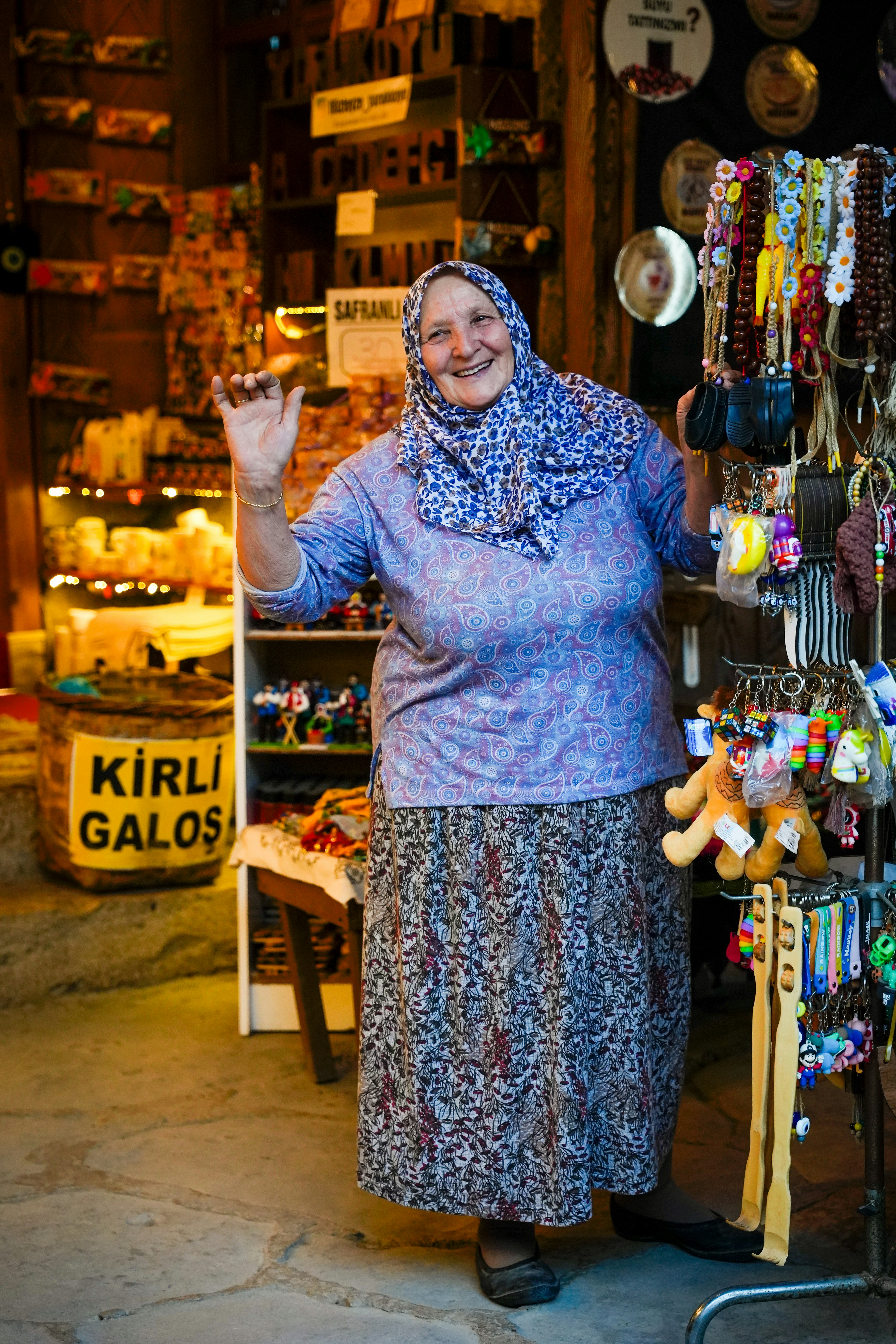 Smiling Elderly Vendor at Souvenir Stall