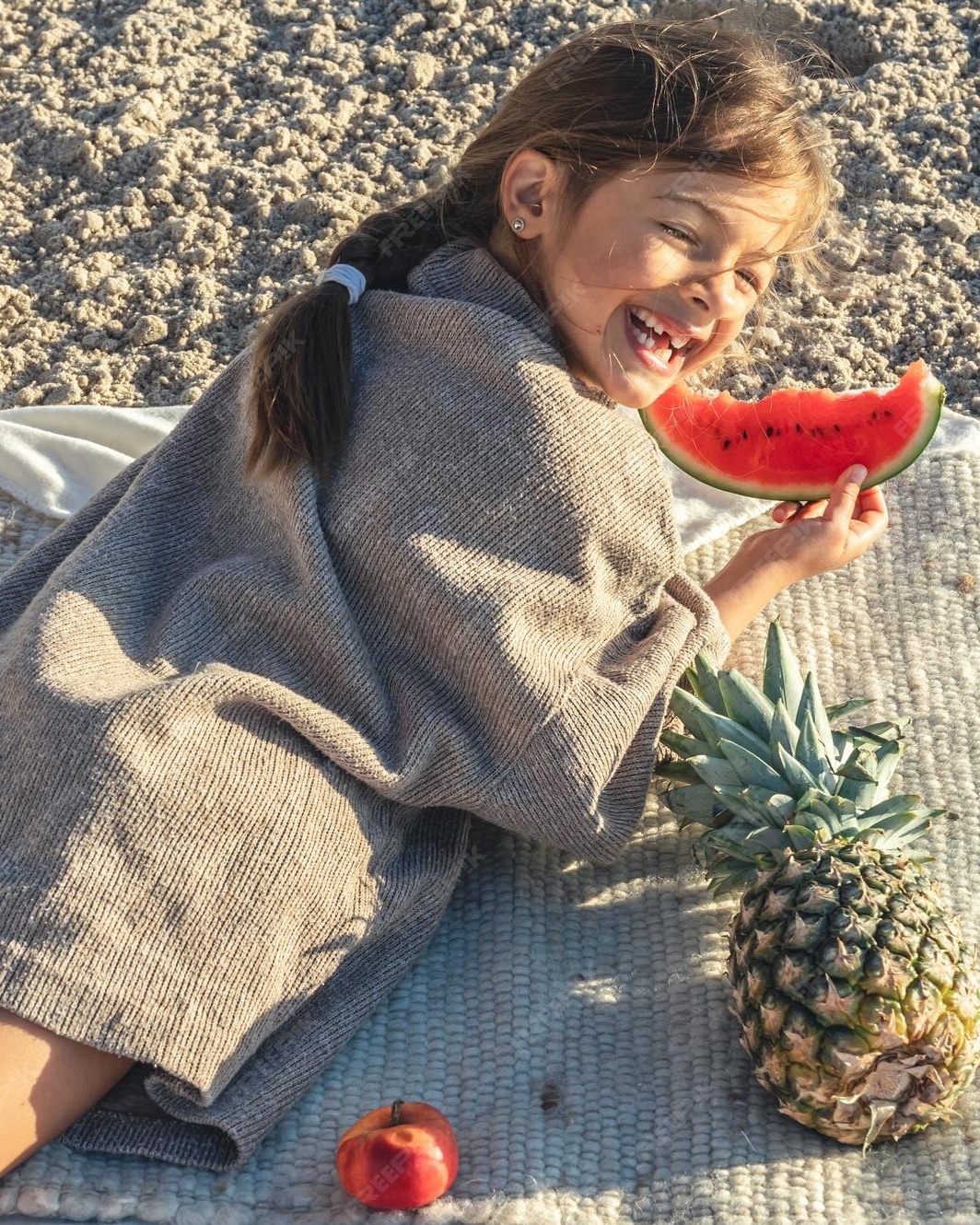 Laughing Girl Picnicking on Sandy Beach