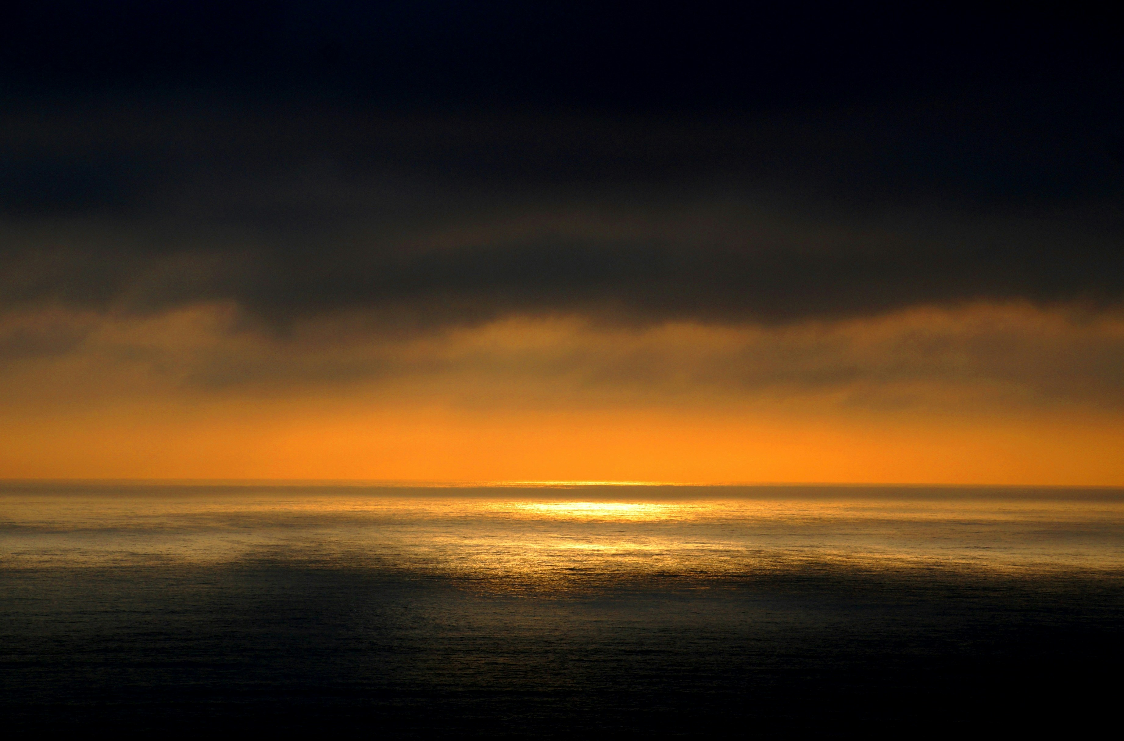 Ocean Sunset Under Dark Clouds