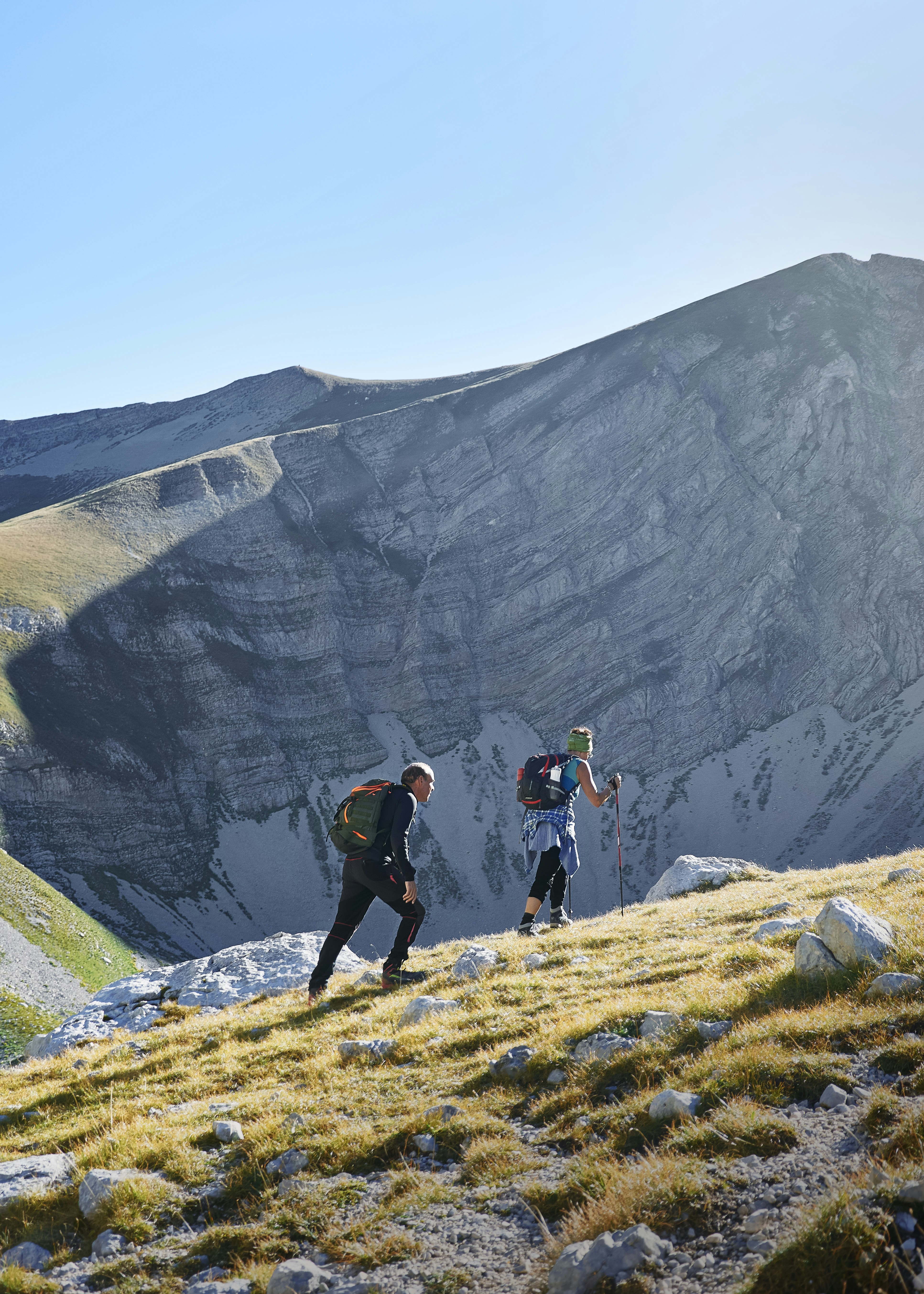 Two Hikers Ascending Mountain Slope