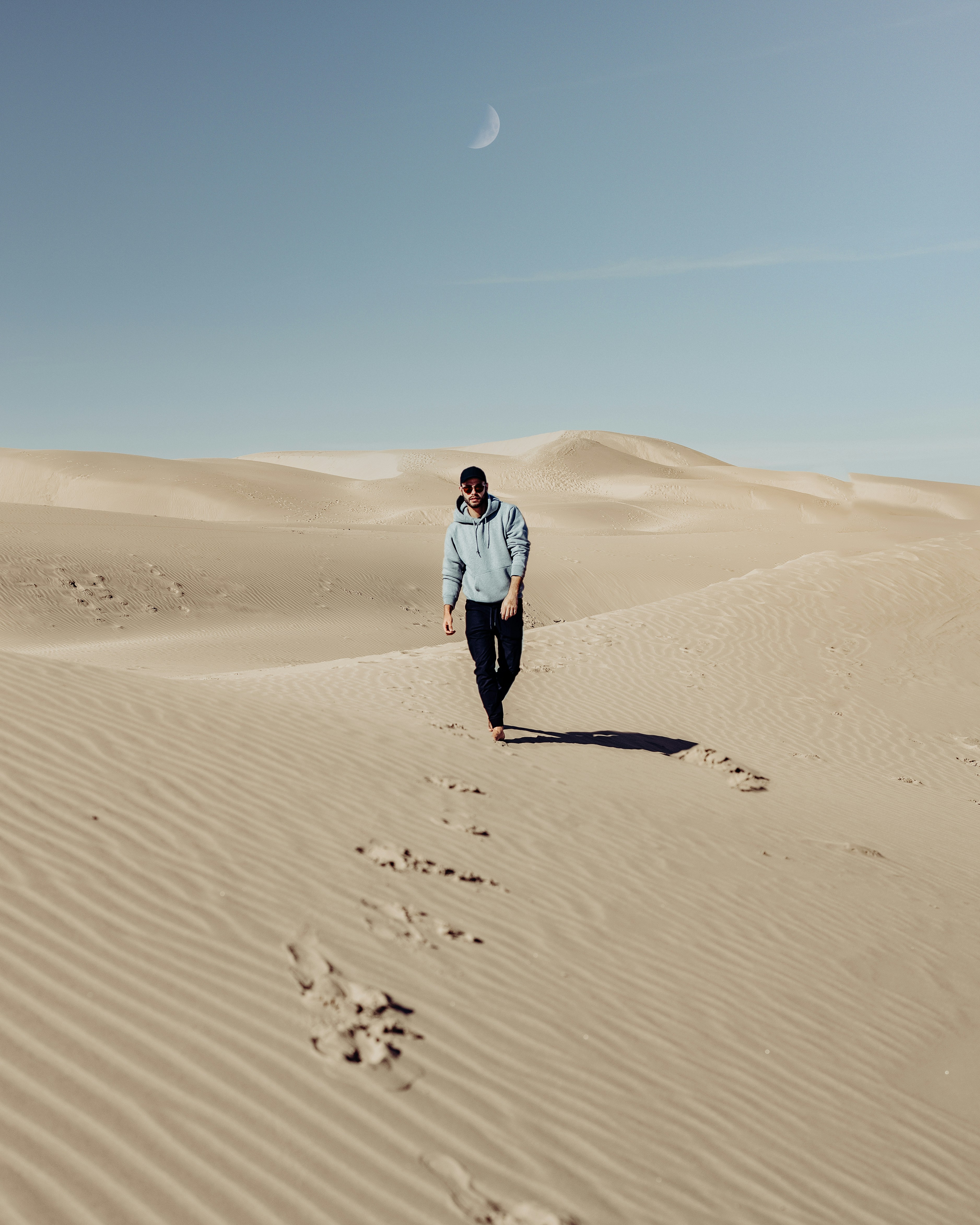 Man Walking on Desert Sand Dunes