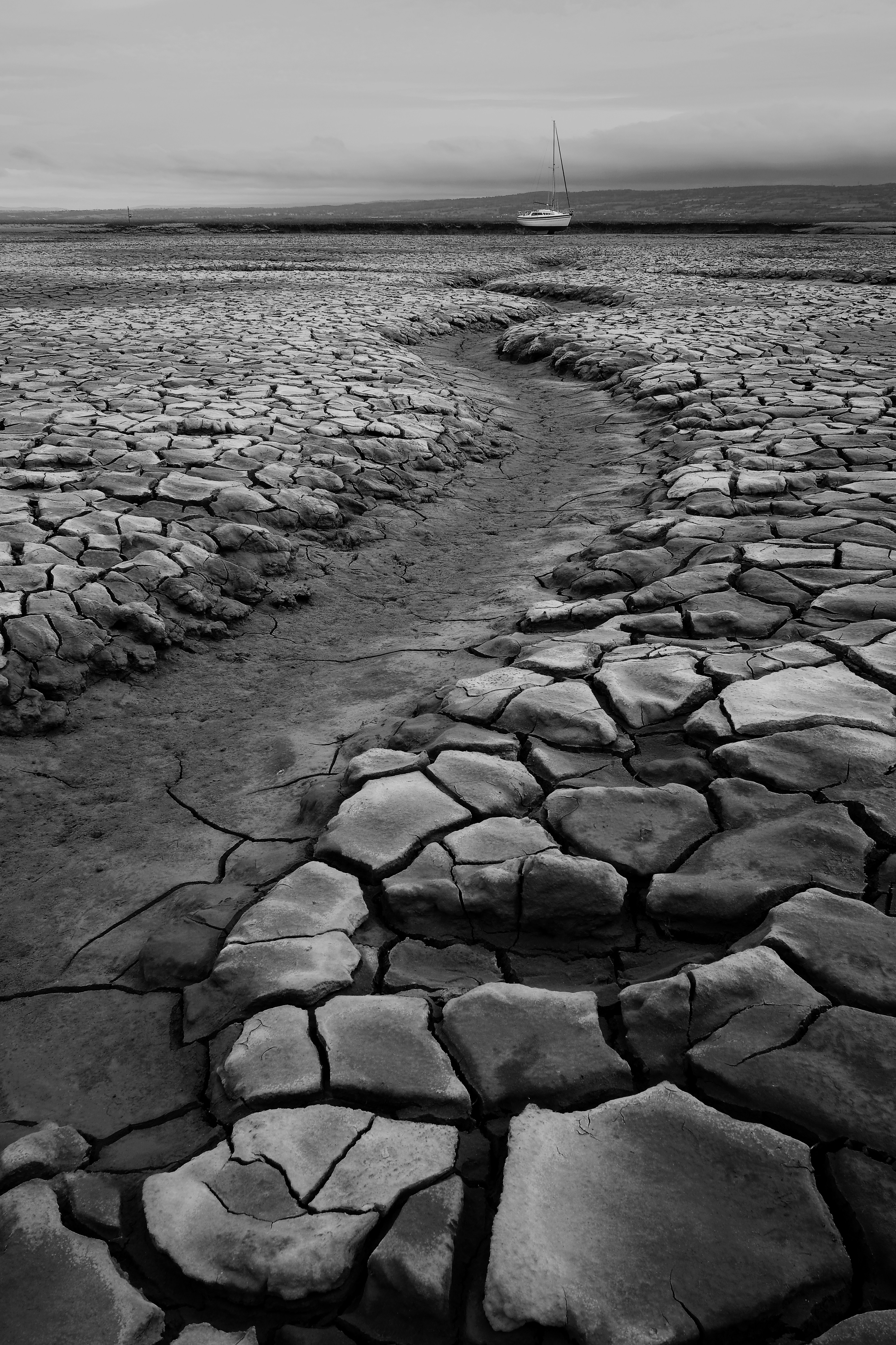 Dried Cracked Riverbed with Stranded Boat