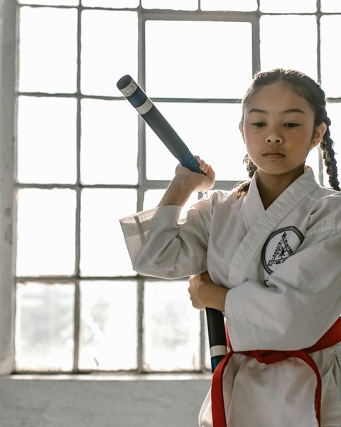 Young Martial Artist Holding Nunchaku
