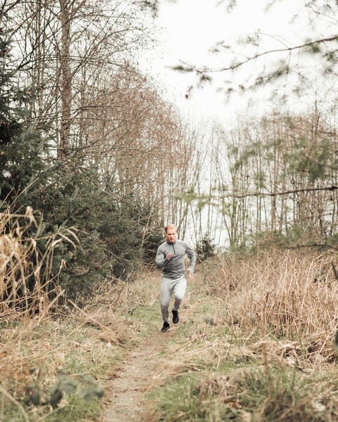 Man Trail Running on Forest Path