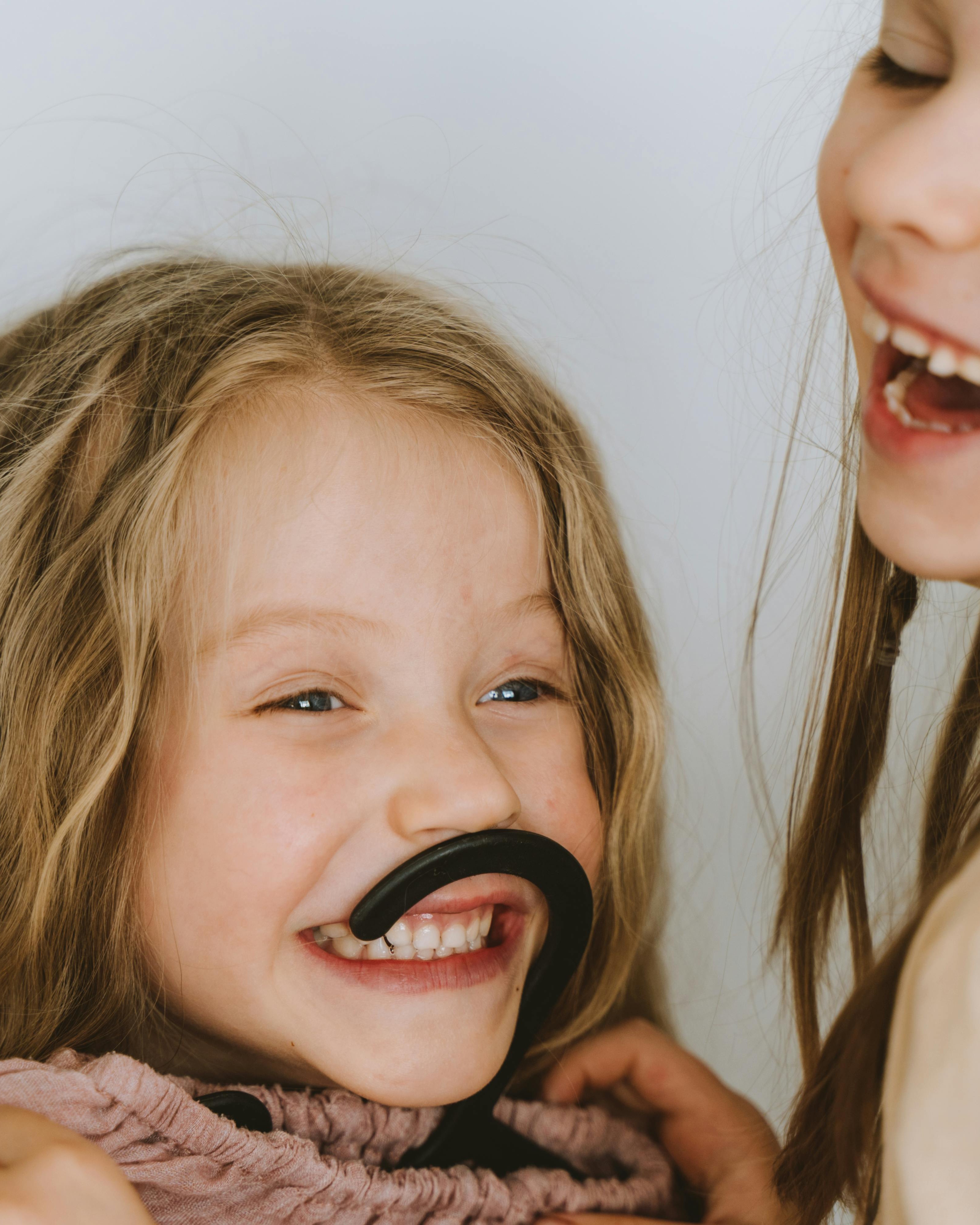 Girls Playing With Fake Mustache