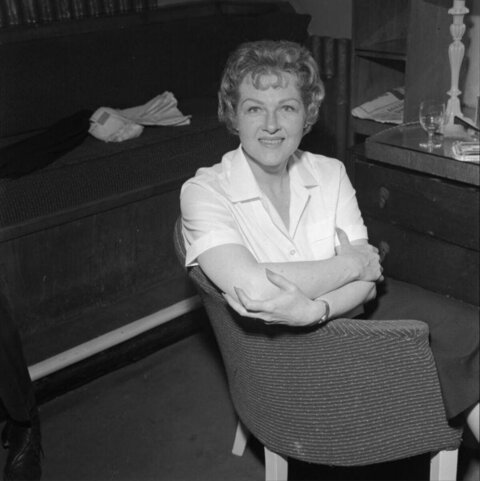 Smiling Woman Sitting Backwards on Chair