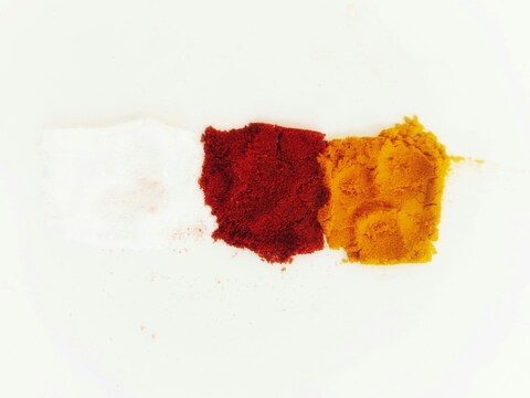 Three piles of colored spice powder