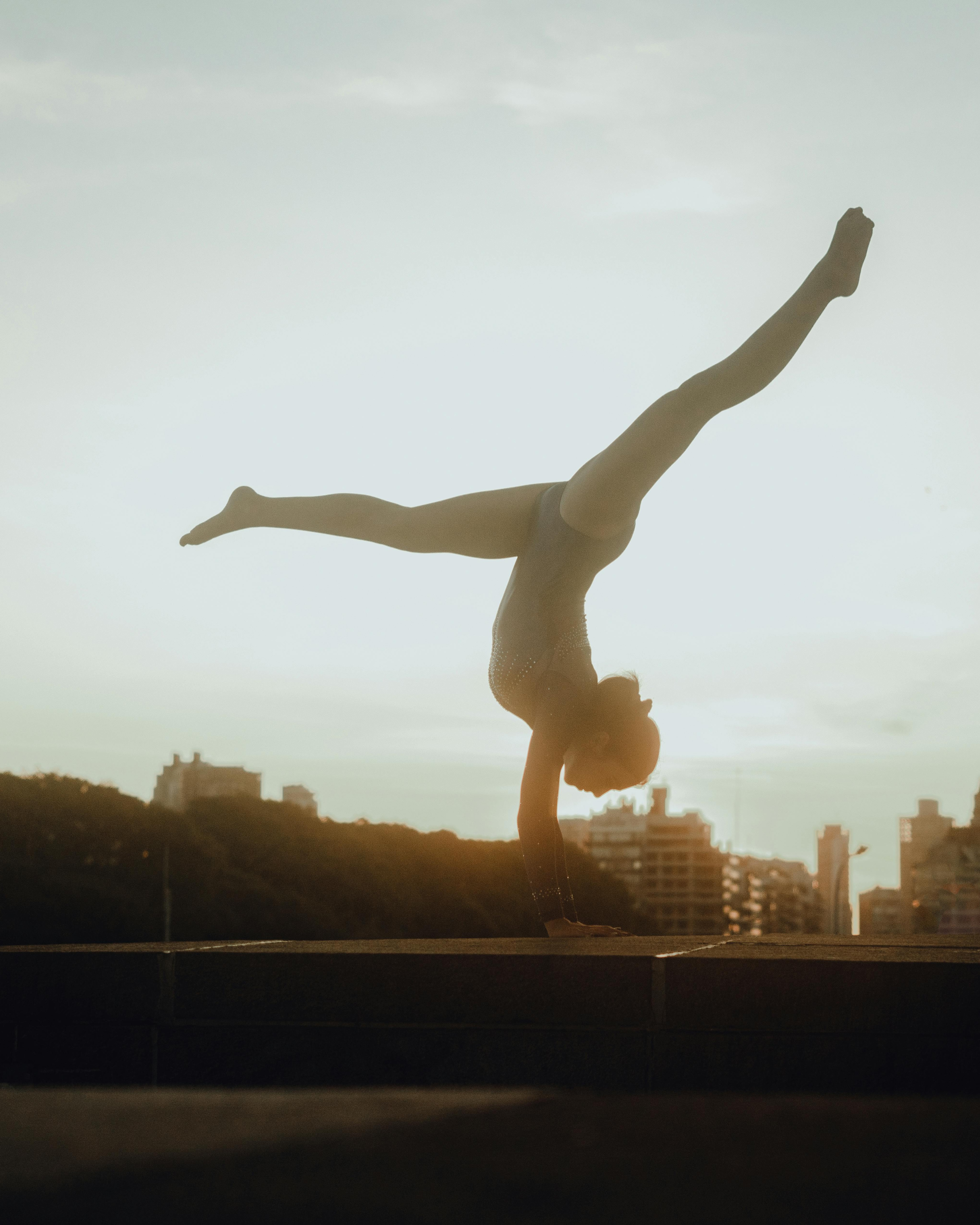 Gymnast Doing Handstand Split at Sunset