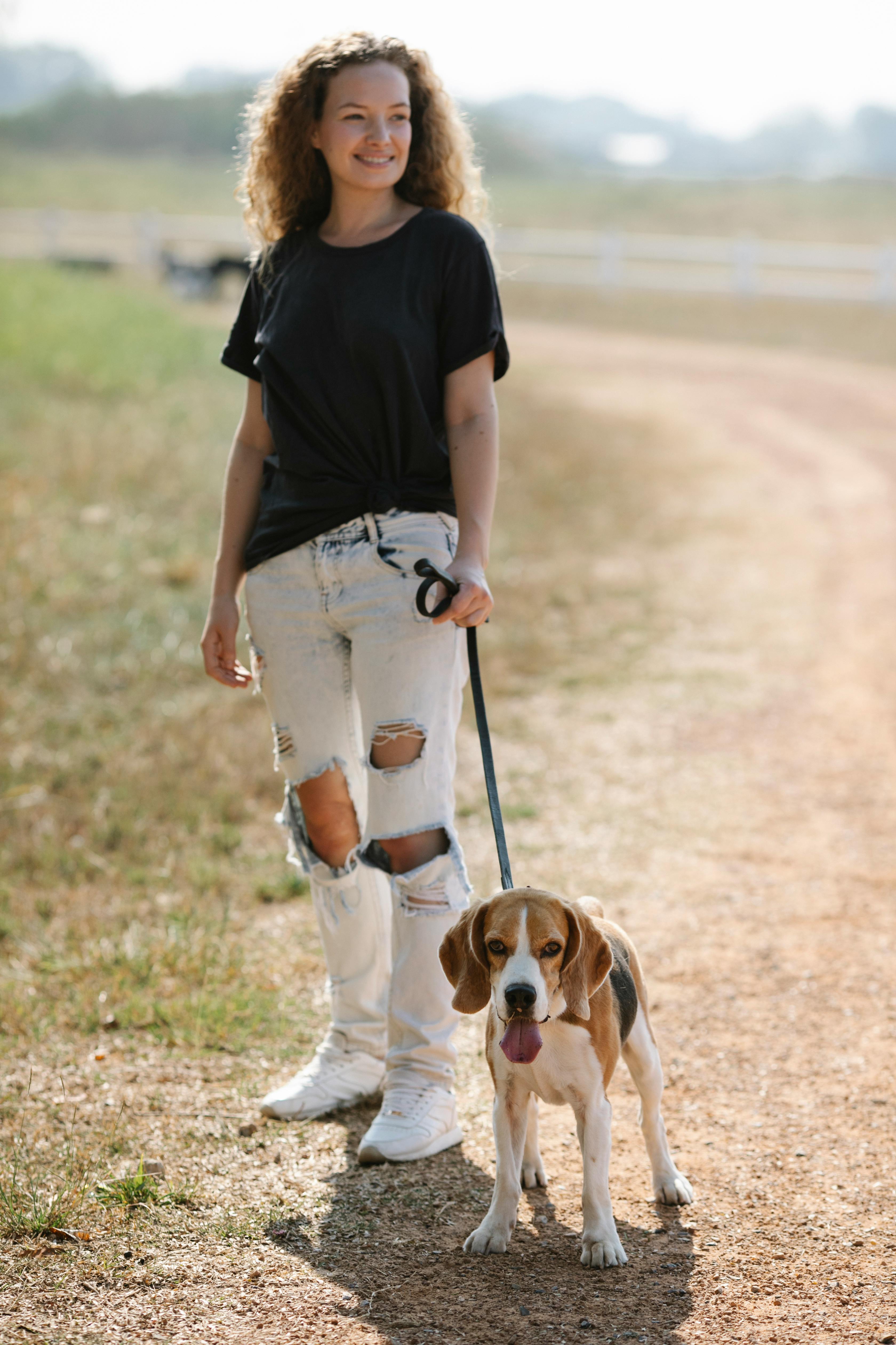 Woman Walking Beagle on Country Path