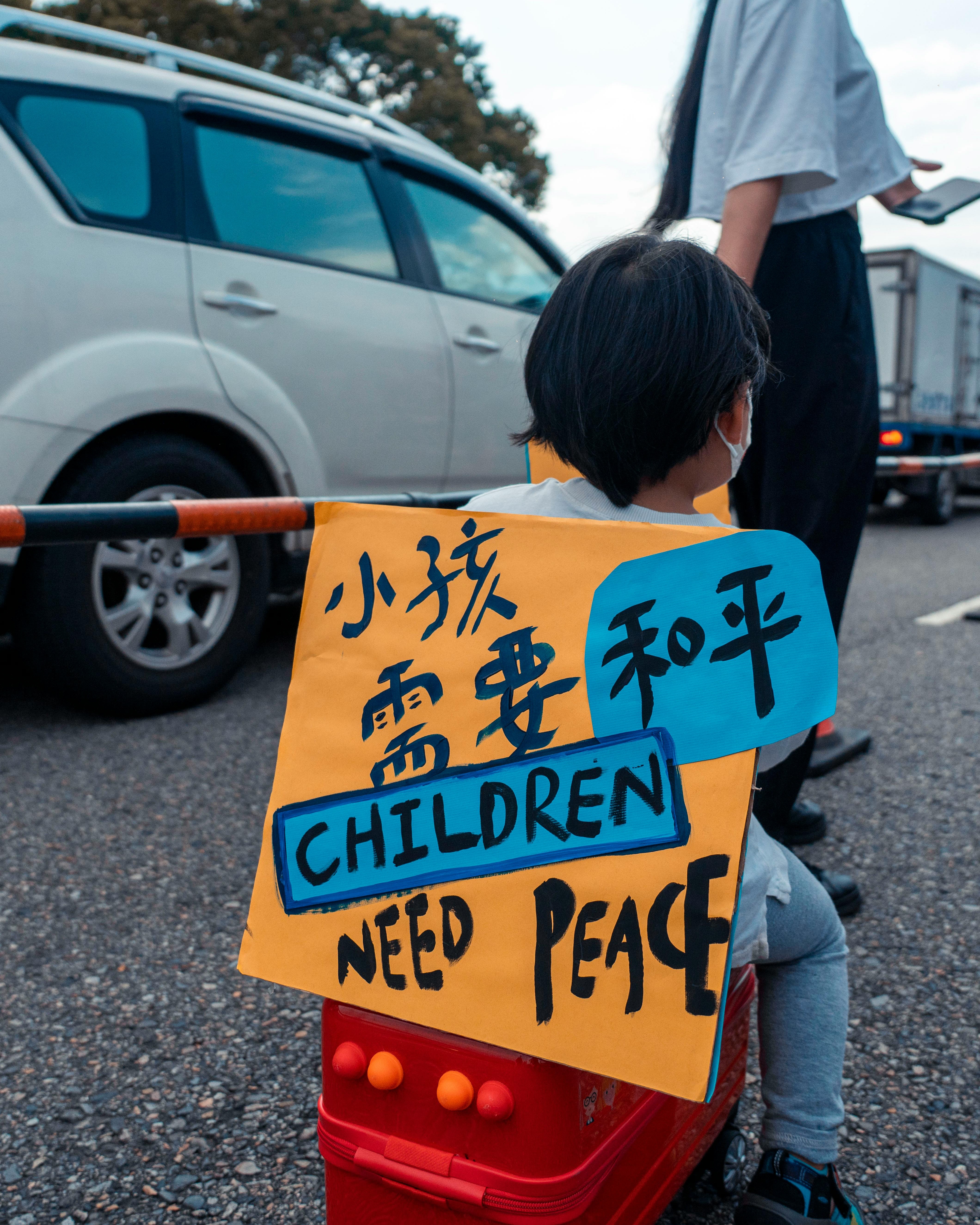 Child Holding Children Need Peace Sign