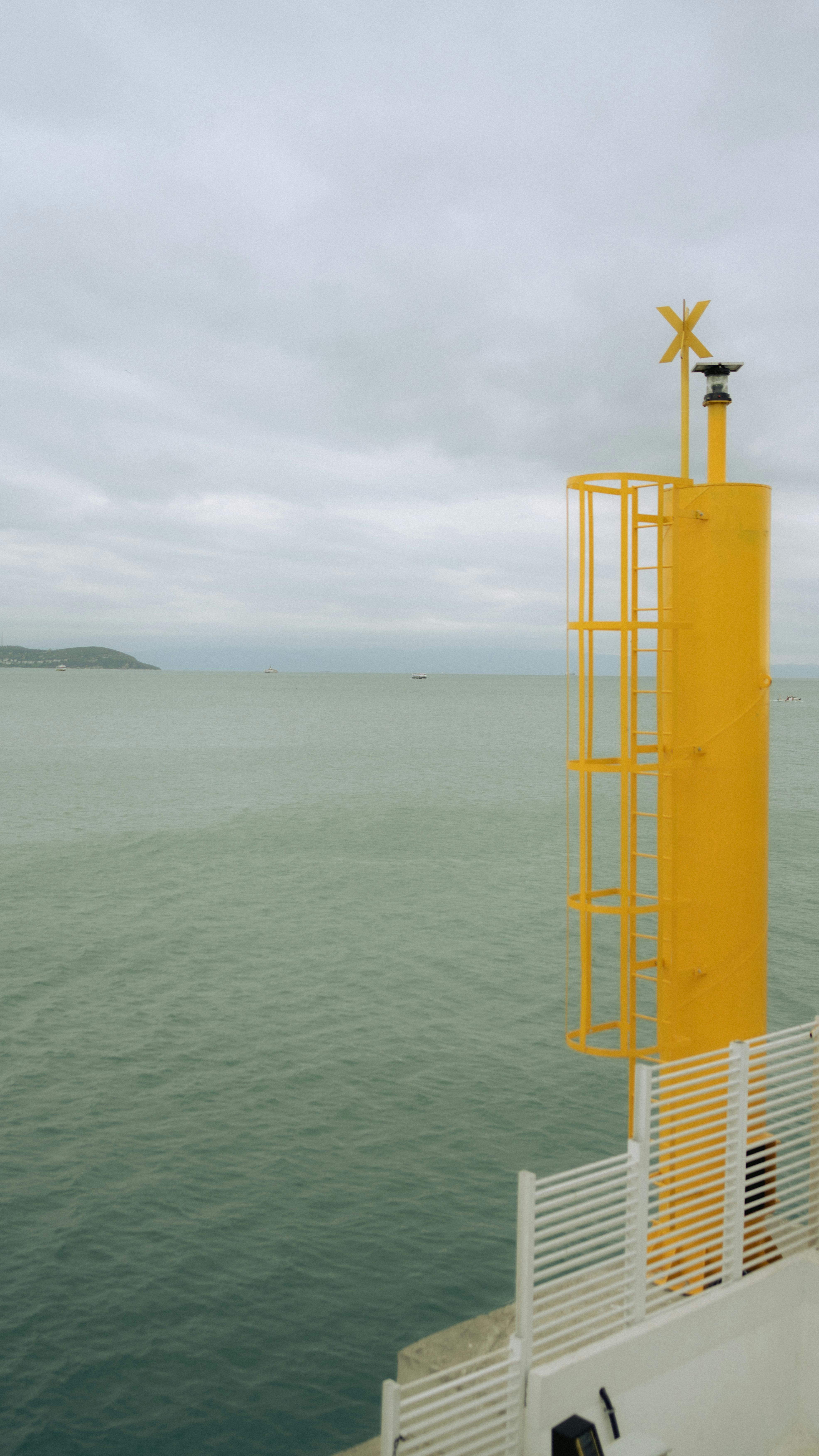 Yellow Navigation Marker by the Sea