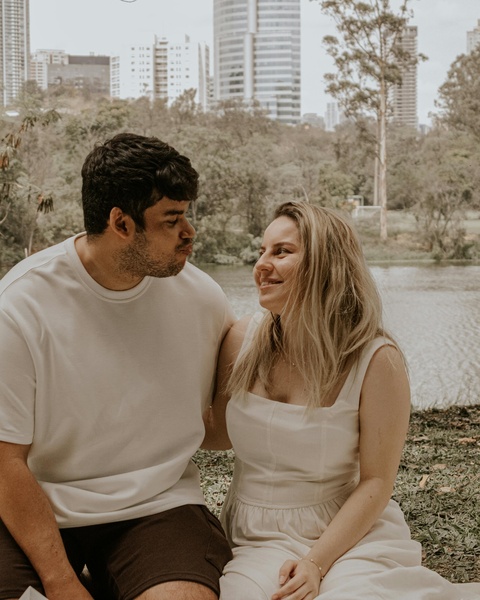 Couple Sitting by Urban Park Lake