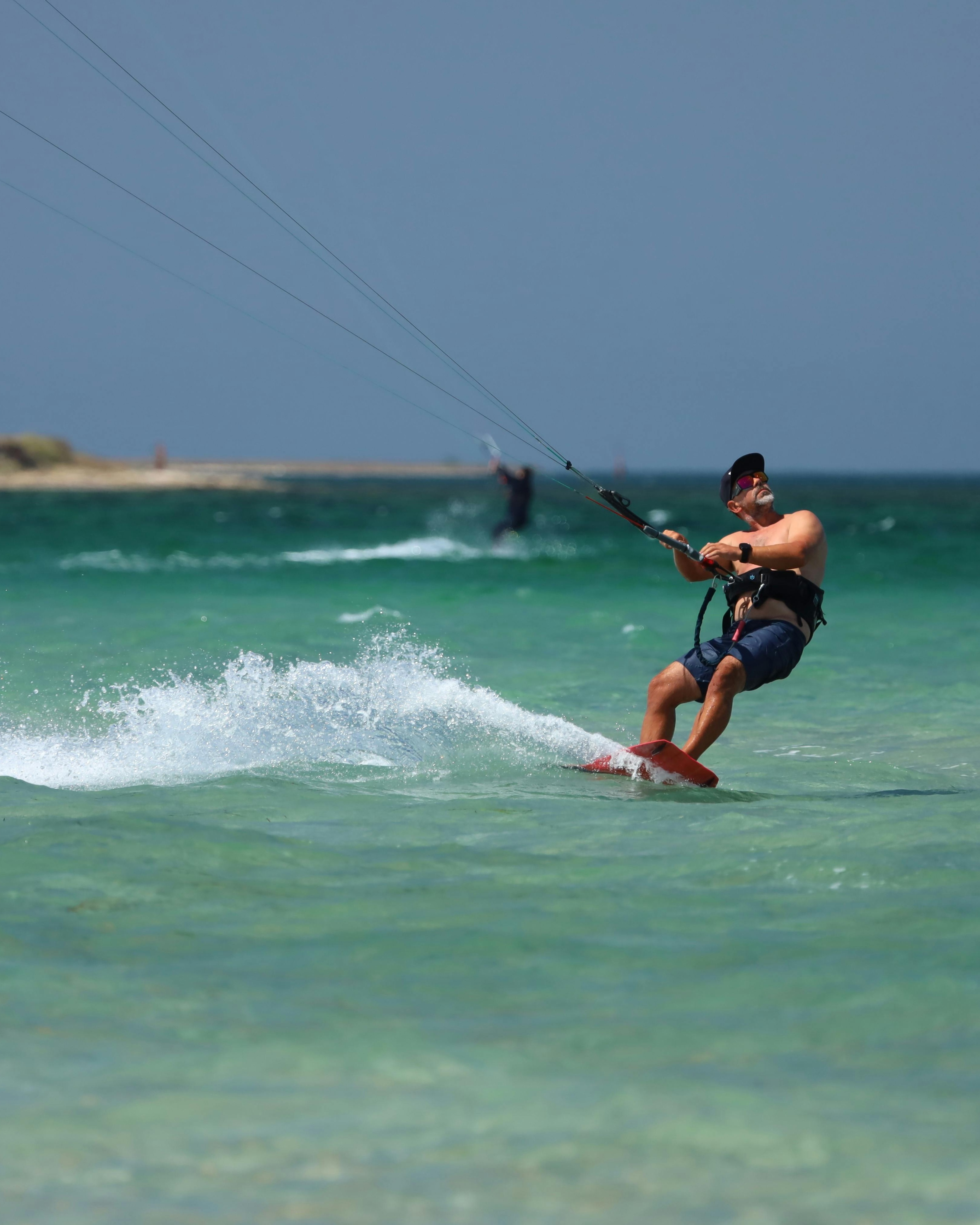 Man Kitesurfing on Turquoise Sea