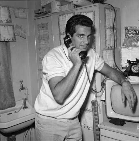 Man Talking on Telephone in Dressing Room