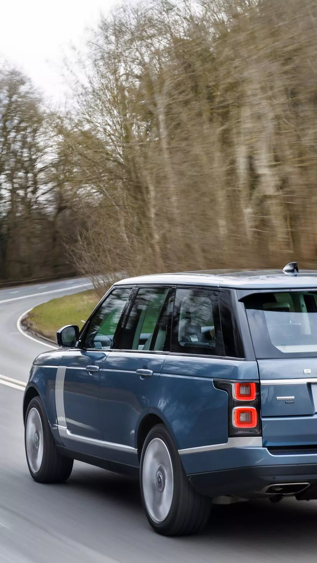 Blue Range Rover on Country Road