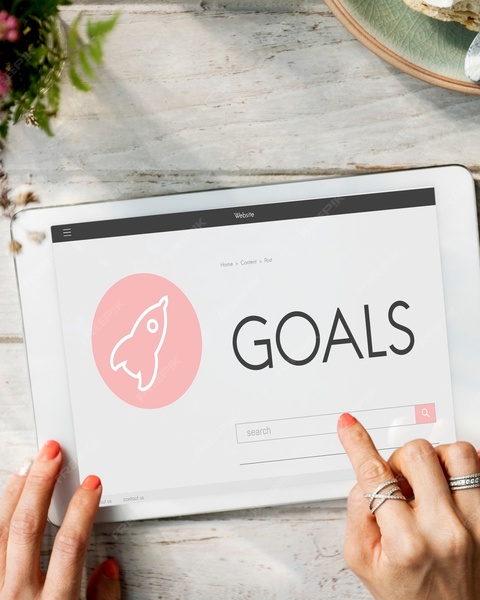 Woman Touching Tablet Showing GOALS