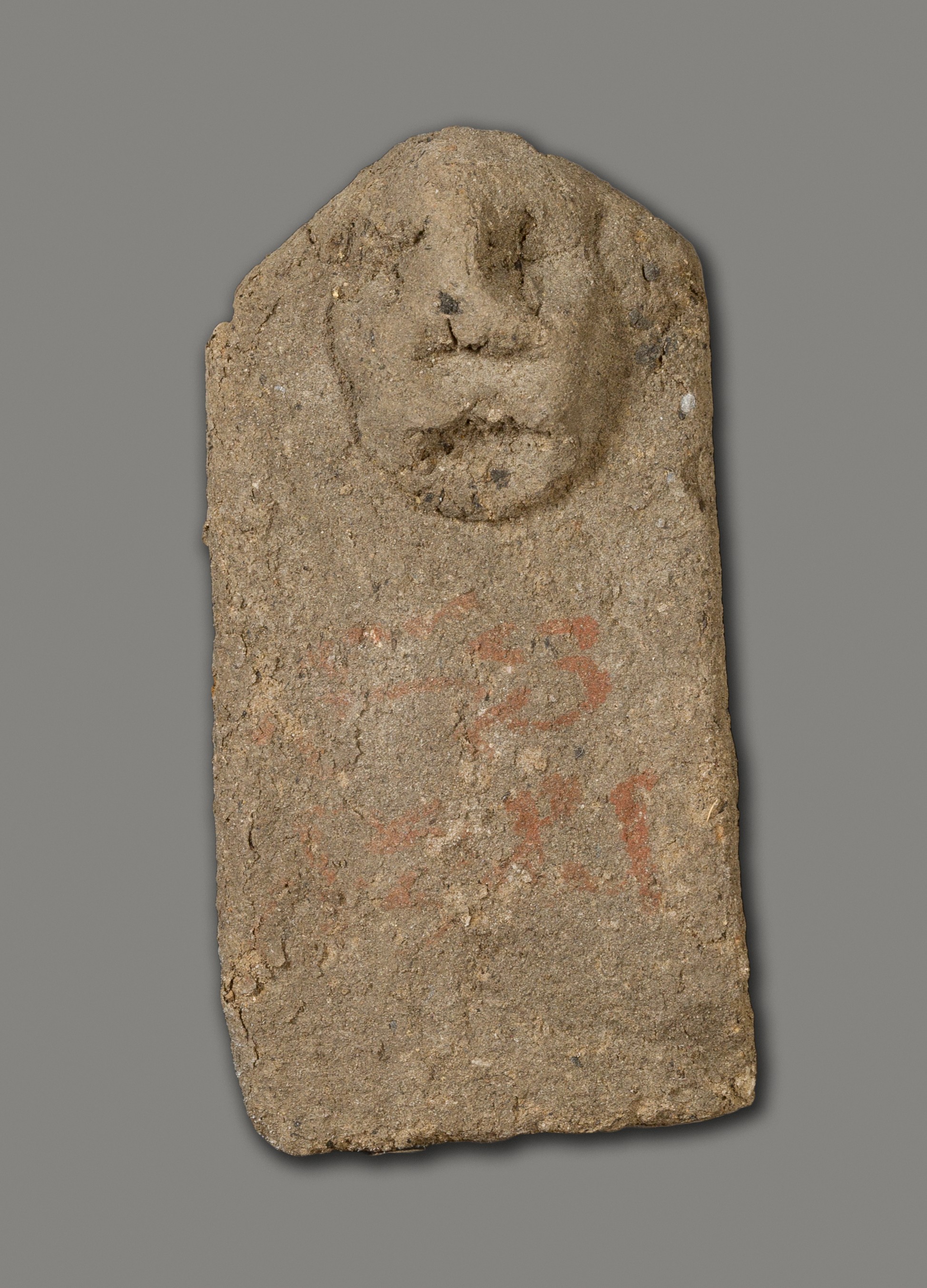 Ancient Clay Artifact with Carved Face