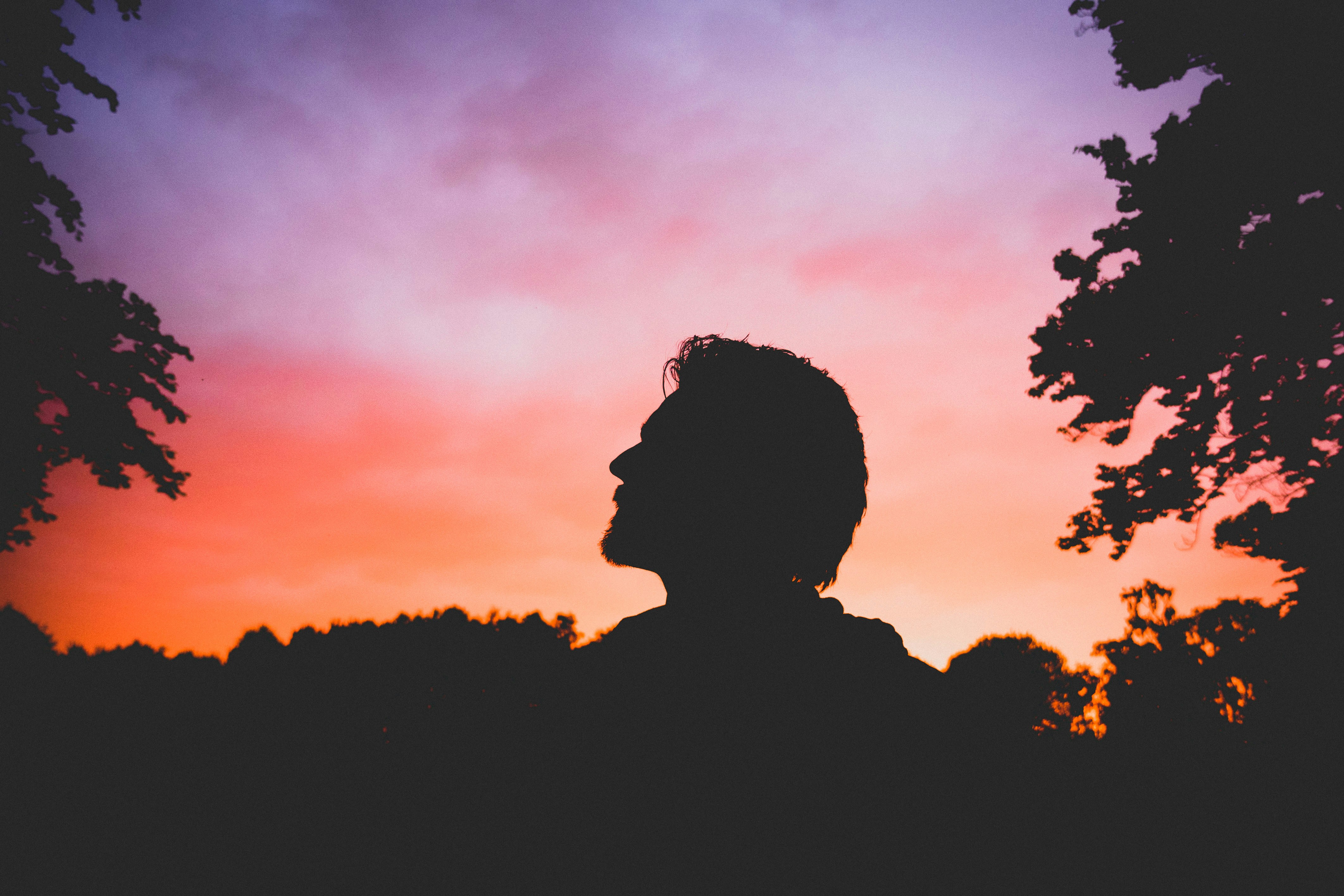 Man Silhouette Against Sunset Sky