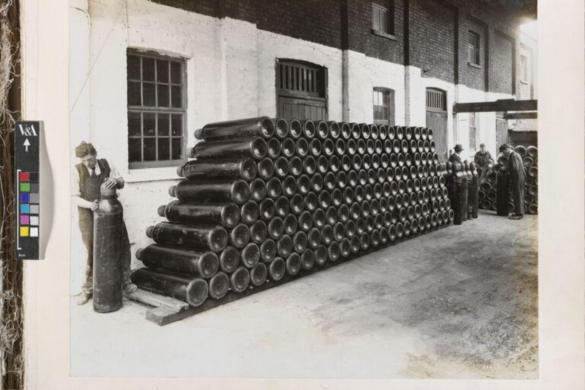 Factory Workers with Stacked Artillery Shells