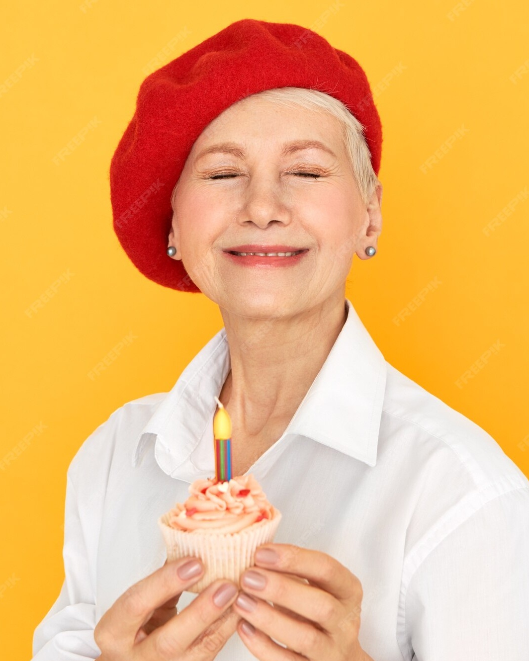 Senior Woman Holding Birthday Cupcake