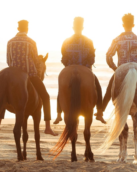 Three Horseback Riders at Beach Sunset