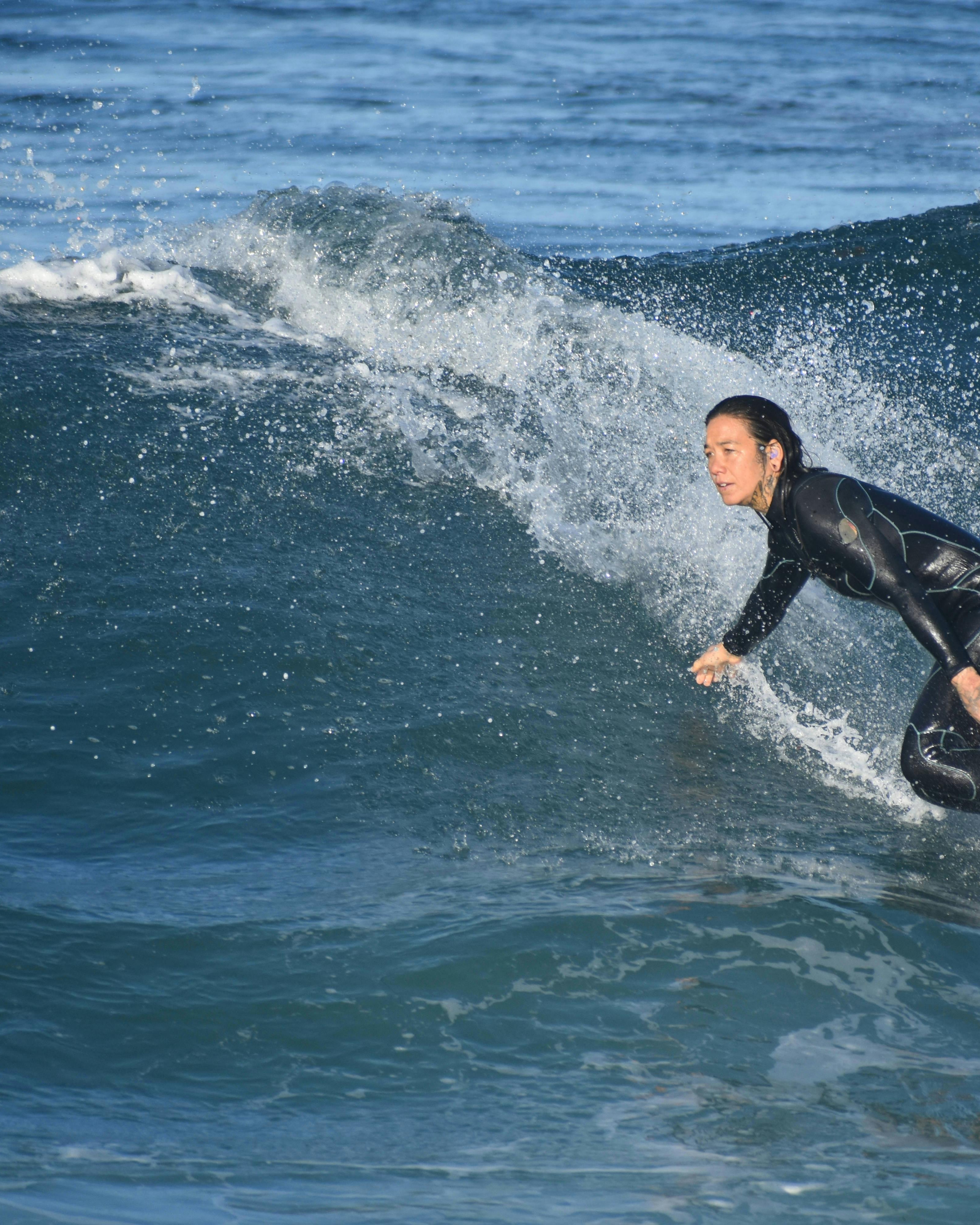 Female Surfer Riding Ocean Wave