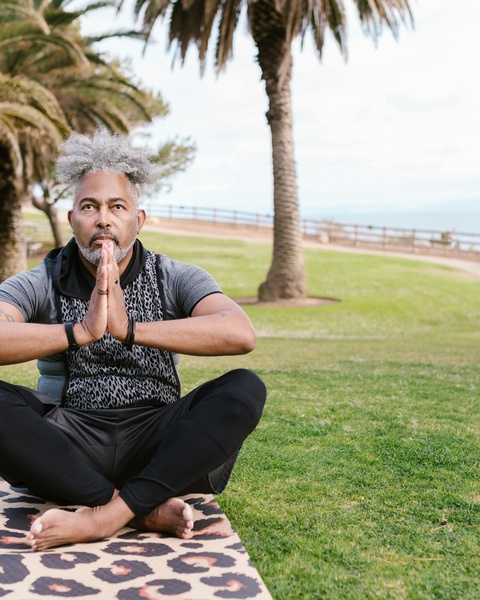 Man Meditating in Coastal Park
