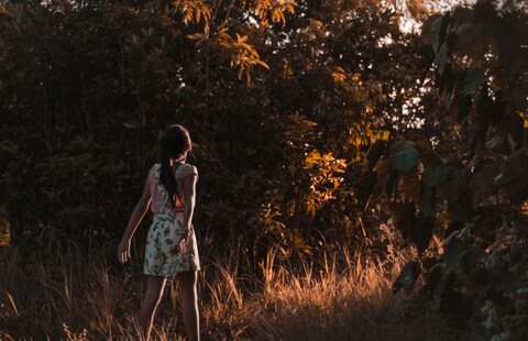 Girl Facing Woods at Golden Sunset