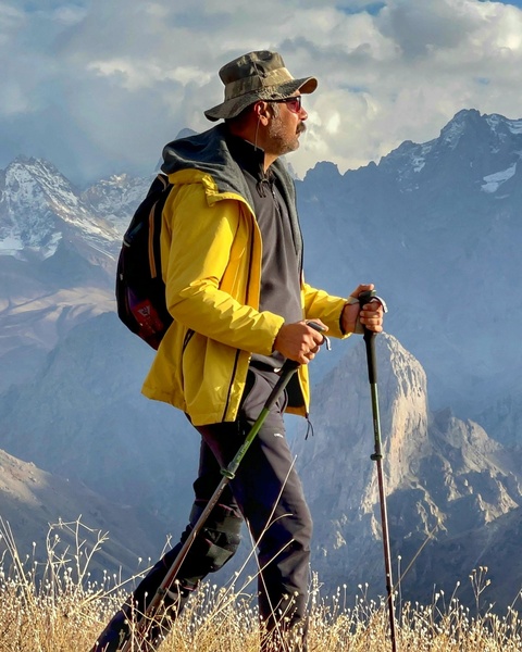 Hiker Trekking in Snow-capped Mountains