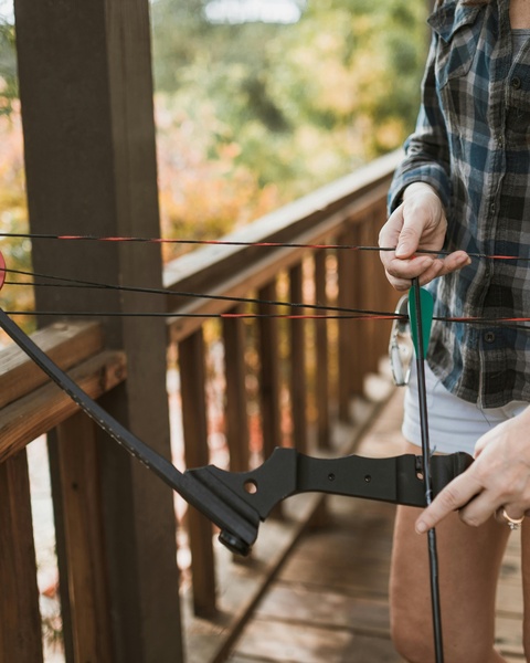 Person Preparing to Shoot Bow and Arrow