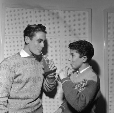 Two Young Men Drinking With Straws