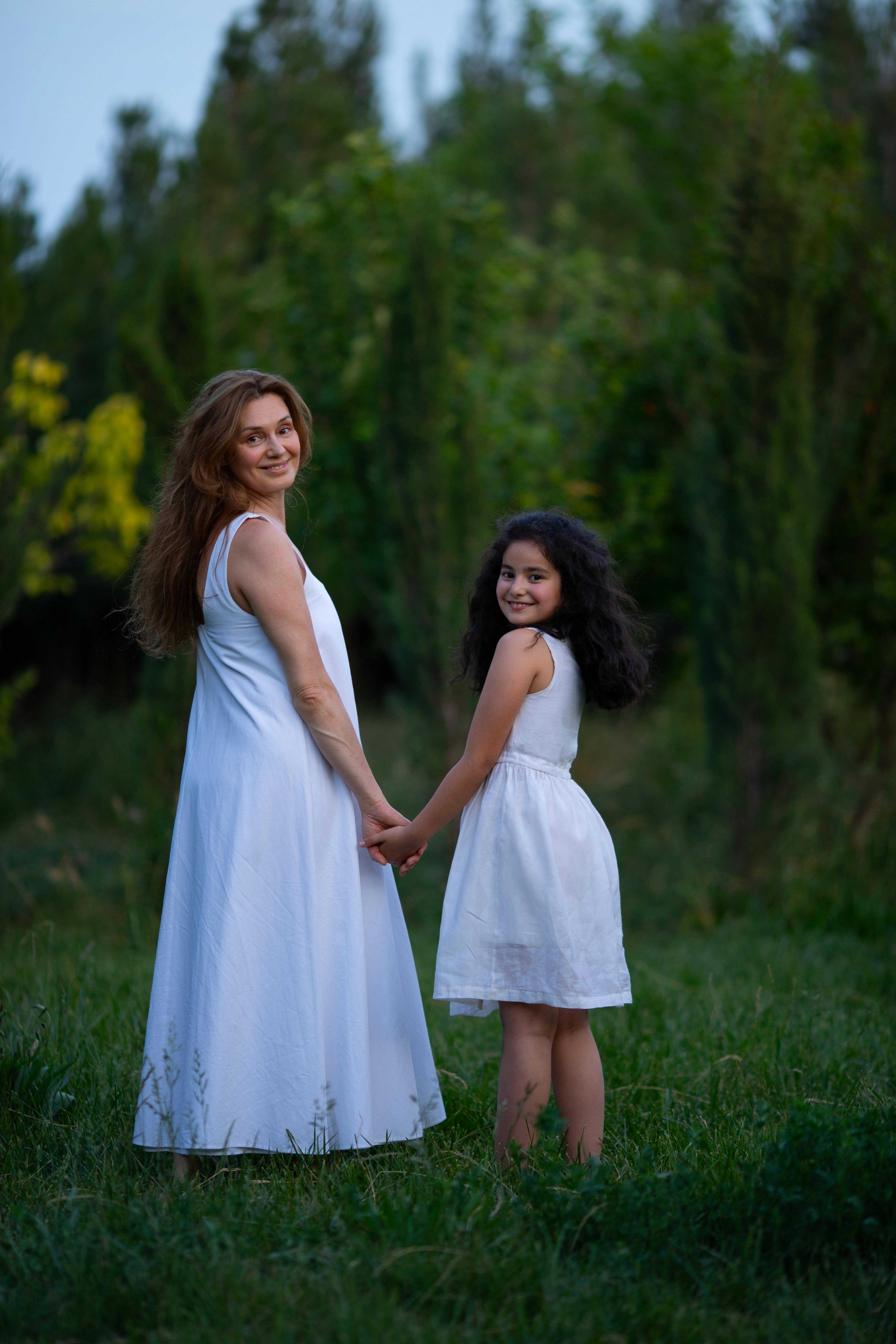 Mother and Daughter Holding Hands Outdoors