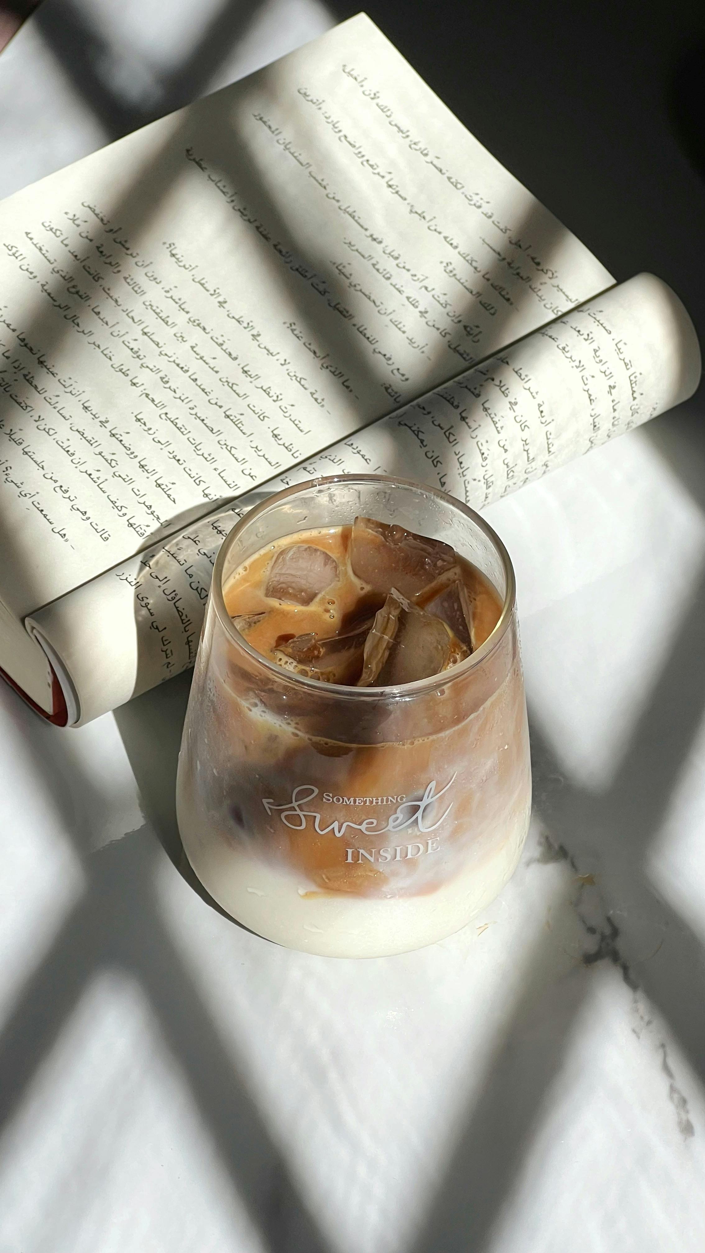 Iced Latte and Open Arabic Book