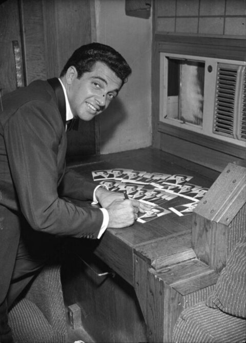 Man Signing Autograph Photos