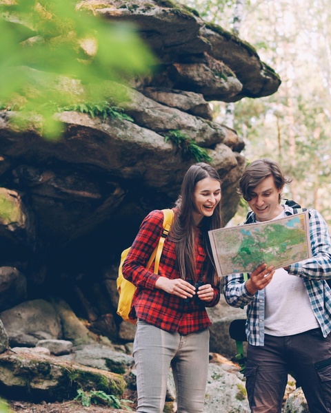 Two Hikers Checking Map in Forest