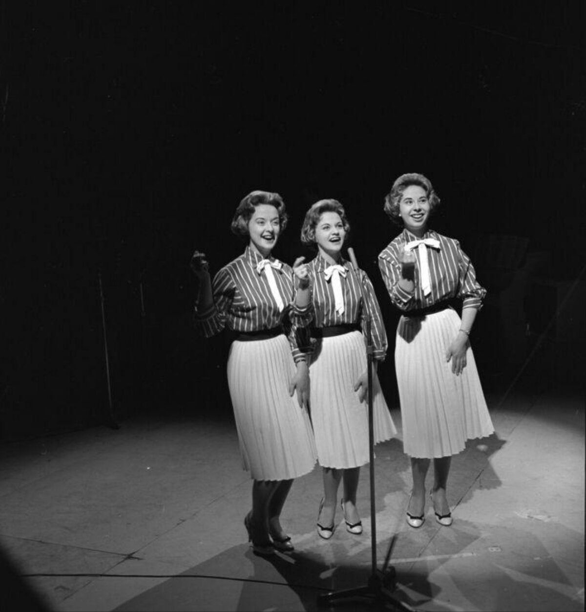 Vocal Trio Performing On Stage
