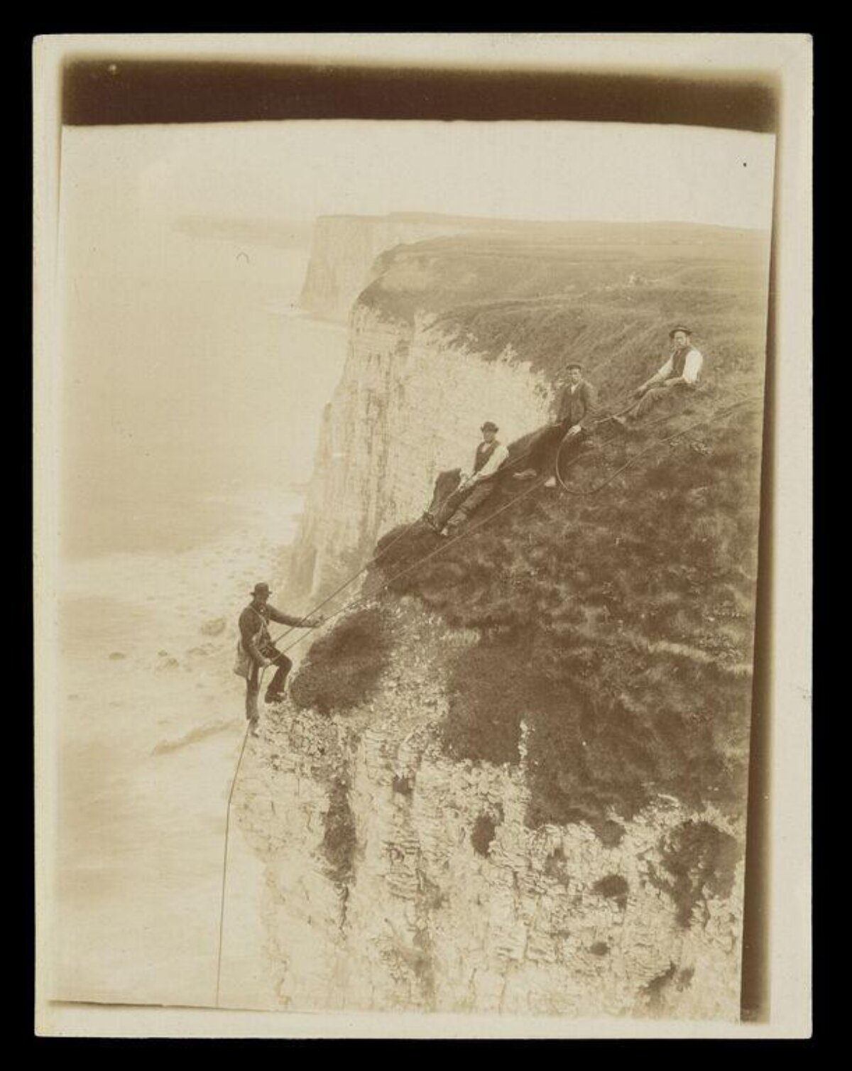 Men Abseiling Coastal Sea Cliffs