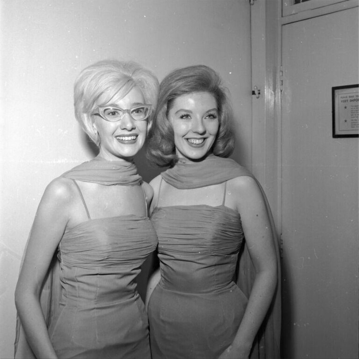 Two Smiling Women In Matching Dresses
