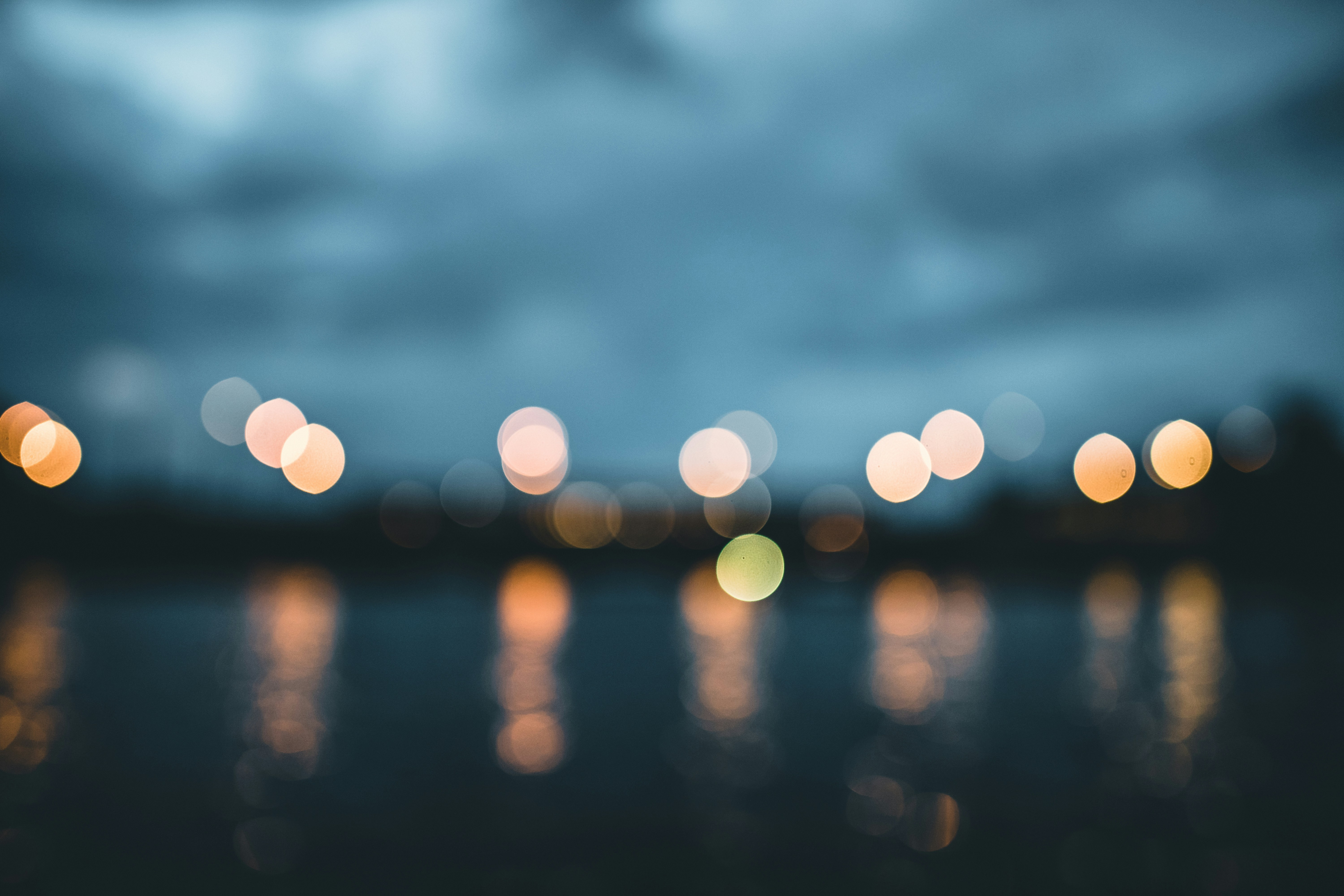 Bokeh Lights Reflected on Water at Dusk