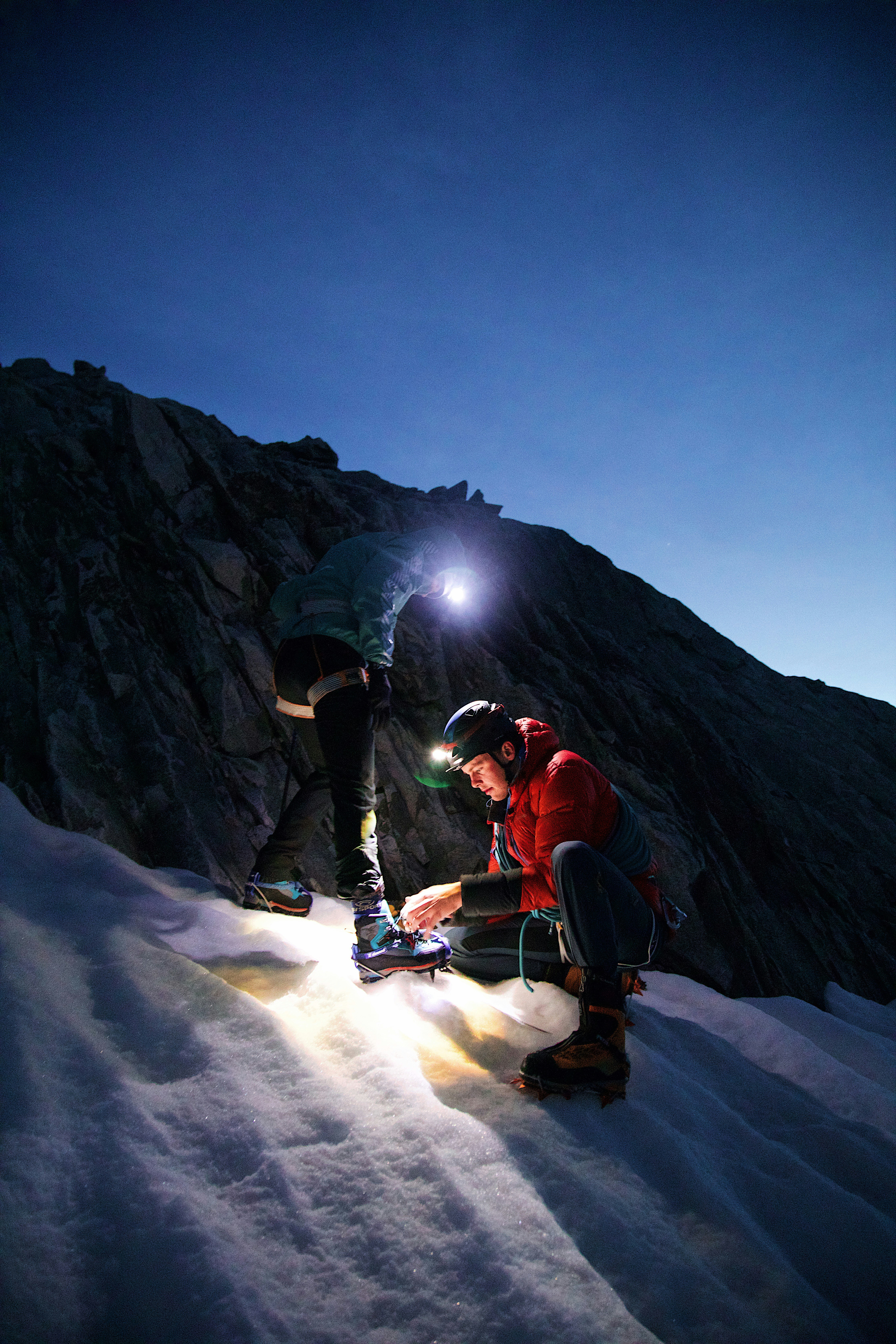 Alpinists Preparing Climbing Gear on Snowy Slope