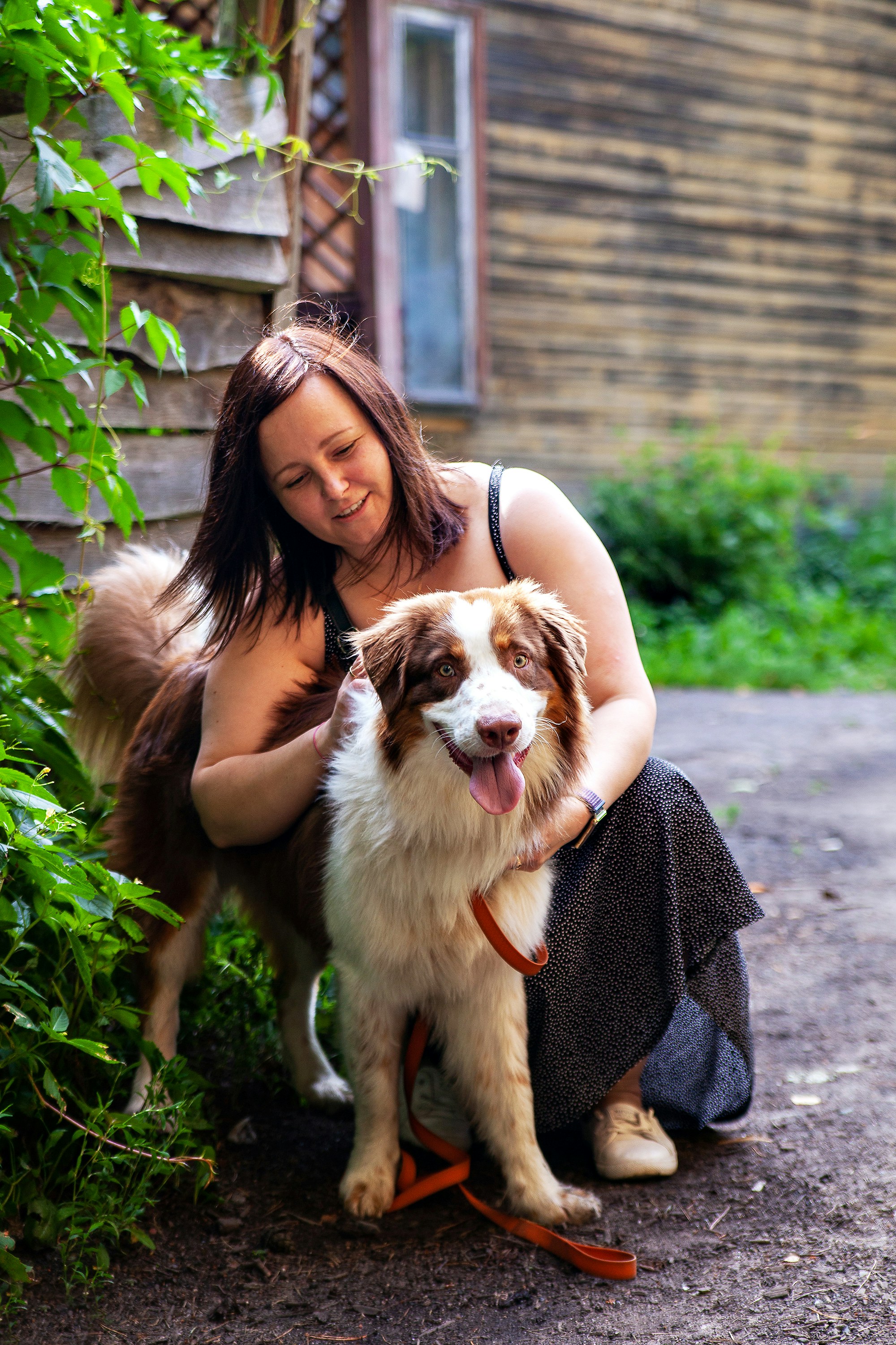 Woman With Happy Pet Dog Outdoors