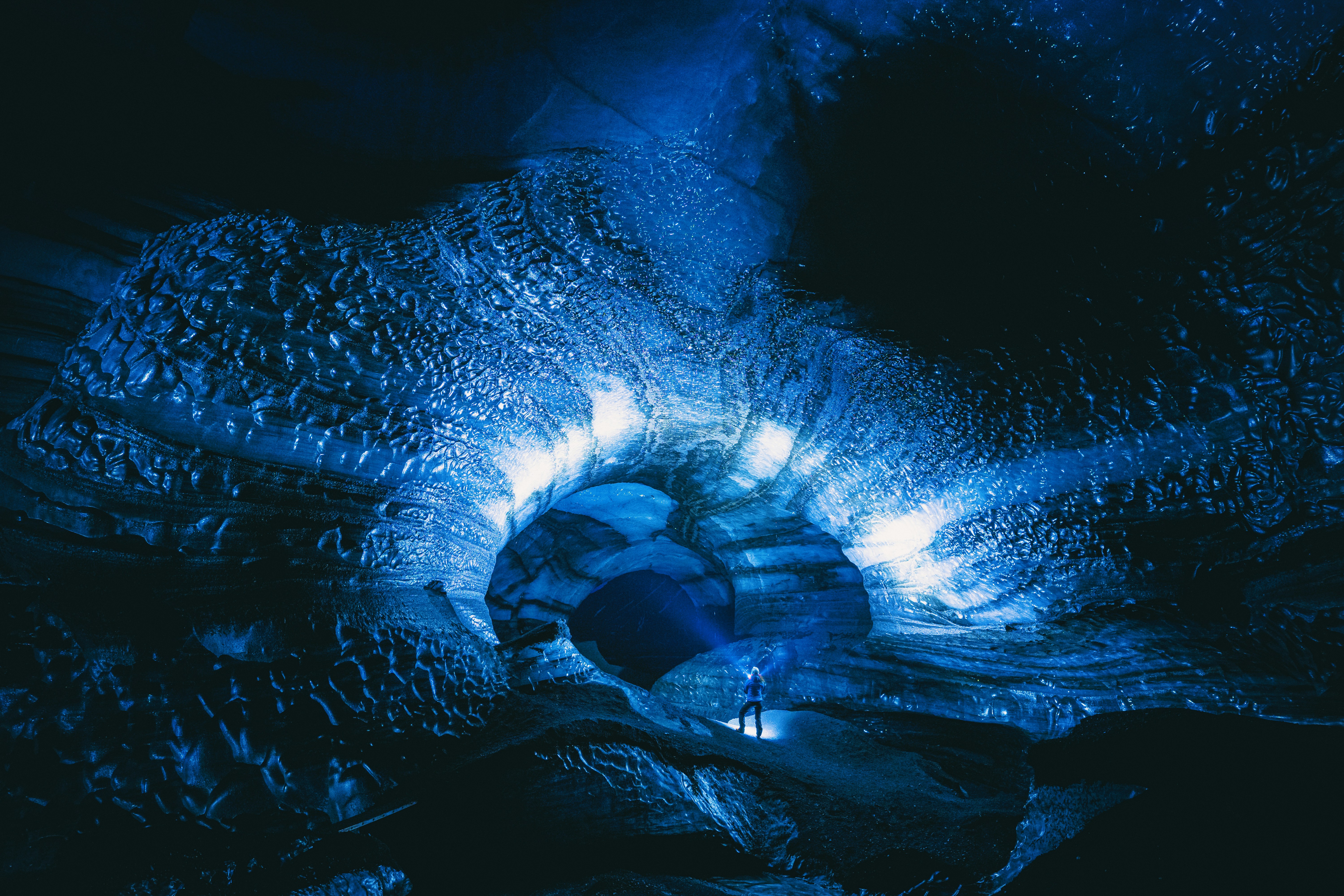 Explorer in Blue Ice Cave