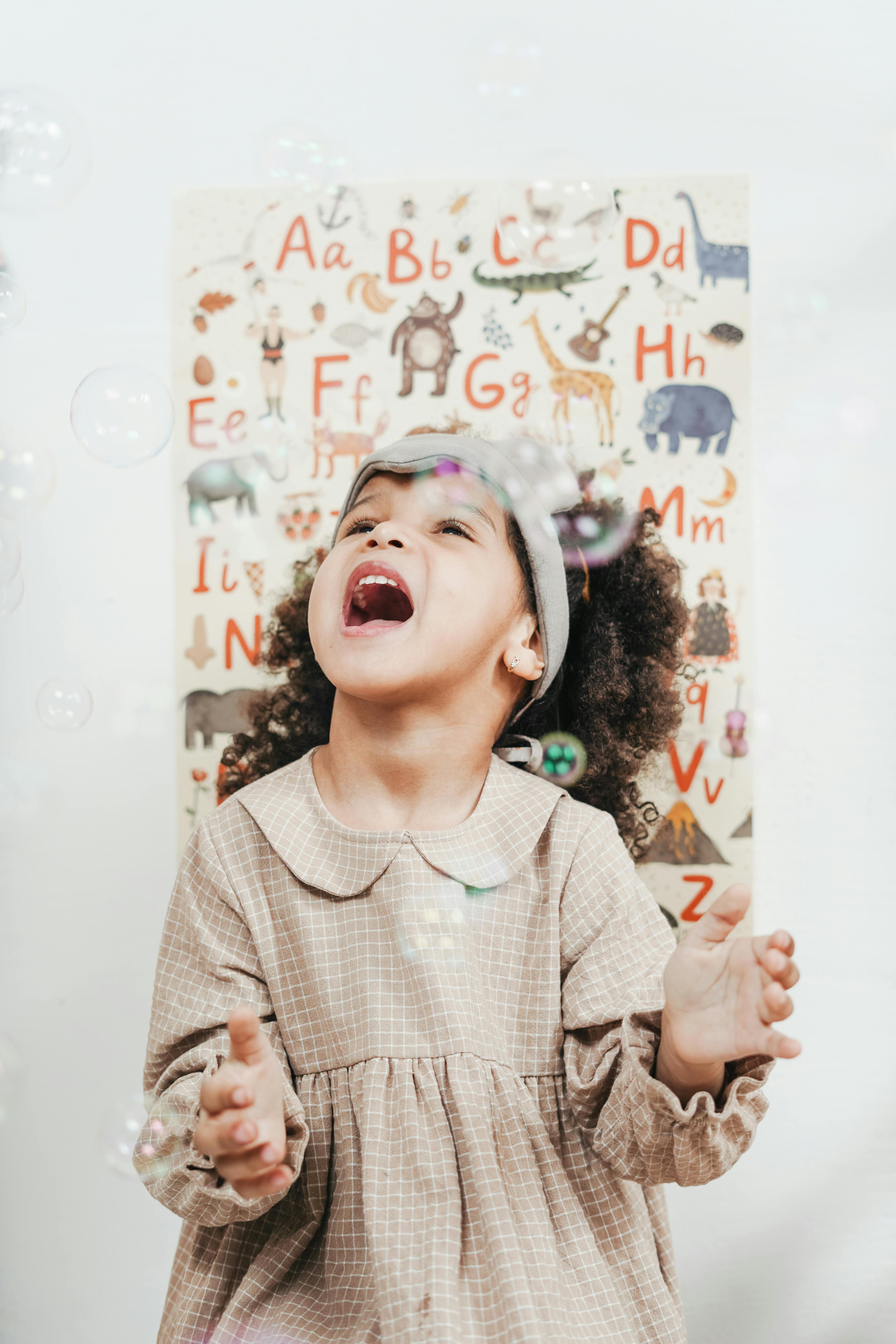 Little Girl Catching Bubbles