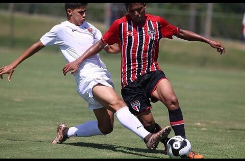 Two Soccer Players Competing for Ball