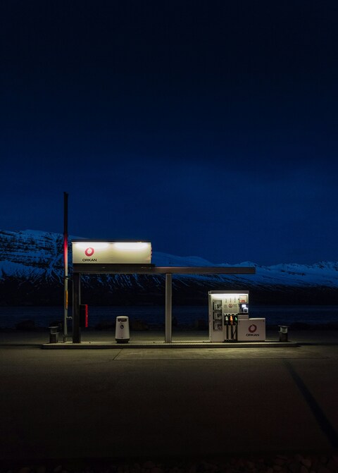 Night Gas Station by Snowy Mountains