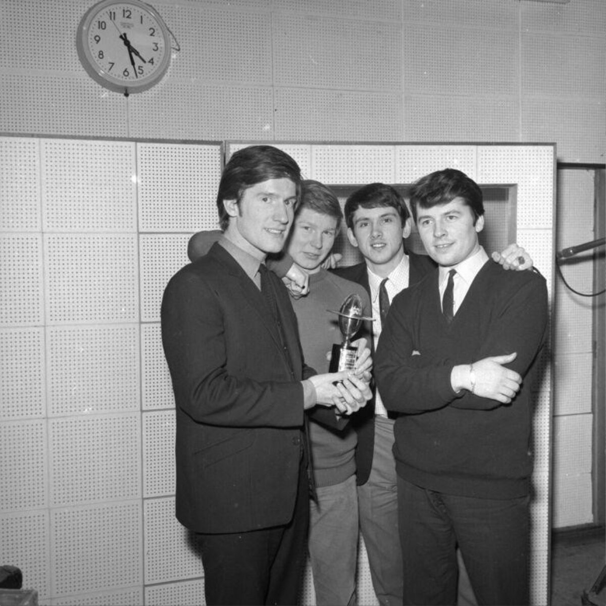 Four Men With Trophy In Recording Studio